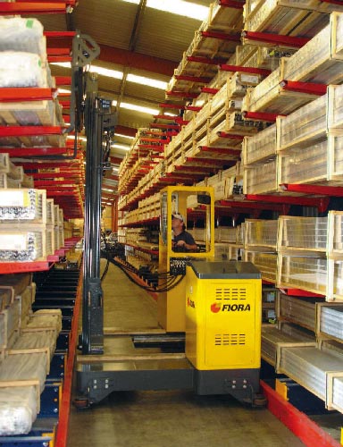 Sideloader in narrow rail guided aisle long load cantilever rack storage