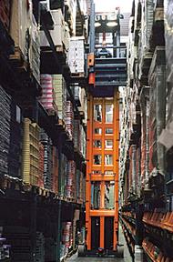 turret truck operating in narrow aisle with conventional pallet racks